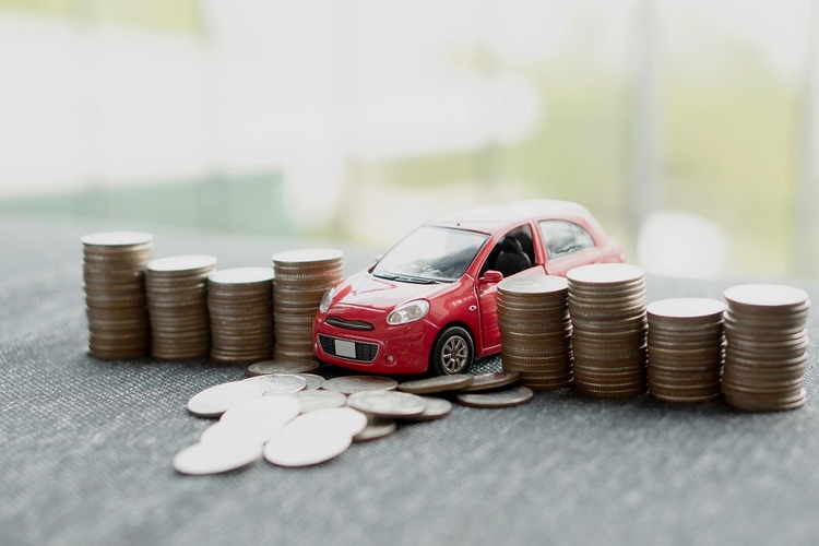 Toy car crashing through stacks of coins